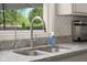Modern kitchen featuring stainless steel faucet, granite countertops, and herringbone backsplash, perfect for cooking at 601 Ridgeview Ln, Columbus, IN 47201