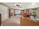 Spacious living room featuring a home theater screen, cozy seating, and a dedicated workspace, illuminated by natural light at 601 Ridgeview Ln, Columbus, IN 47201