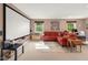 A spacious living room with home theater screen, a comfortable seating area and ample natural light creating an inviting atmosphere at 601 Ridgeview Ln, Columbus, IN 47201