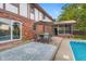 Outdoor patio area includes dining seating and an outdoor carpet near the pool and home at 601 Ridgeview Ln, Columbus, IN 47201