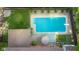 Aerial view of in-ground swimming pool with surrounding patio area, umbrella, and privacy fence at 601 Ridgeview Ln, Columbus, IN 47201