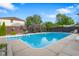A refreshing in-ground pool is surrounded by a fenced yard with vibrant greenery at 601 Ridgeview Ln, Columbus, IN 47201
