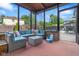 The screened sunroom features cozy seating and views of the pool, perfect for relaxation at 601 Ridgeview Ln, Columbus, IN 47201