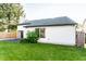 The backyard features a lush lawn, mature trees, and a white house exterior at 6140 King Lear Ln, Indianapolis, IN 46254