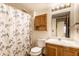 Bright bathroom with a shower, vanity, toilet, and mirror with lighting at 6140 King Lear Ln, Indianapolis, IN 46254
