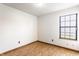 Bright bedroom featuring hardwood floors and a large window for natural light at 6140 King Lear Ln, Indianapolis, IN 46254