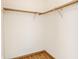 Inside of an empty closet with two wooden racks at 6140 King Lear Ln, Indianapolis, IN 46254