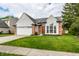 Attractive home with a manicured lawn and convenient two-car garage at 6140 King Lear Ln, Indianapolis, IN 46254