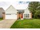 Inviting exterior showcasing a well-manicured lawn and attached two-car garage at 6140 King Lear Ln, Indianapolis, IN 46254