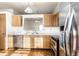 Practical kitchen layout featuring stainless appliances and light wood cabinets at 6140 King Lear Ln, Indianapolis, IN 46254