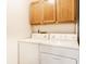 Bright laundry room featuring a washer, dryer, and storage cabinets at 6140 King Lear Ln, Indianapolis, IN 46254