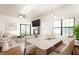 Open living room and dining area featuring a fireplace, hardwood floors, and ample natural light at 6140 King Lear Ln, Indianapolis, IN 46254
