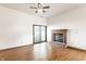 Spacious living room featuring a fireplace, hardwood floors, and sliding glass door to the outside at 6140 King Lear Ln, Indianapolis, IN 46254