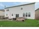 Backyard with a patio, dining set, garden box, and green grass at 6164 Brighton Dr, Whitestown, IN 46075