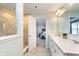 Bathroom featuring double sinks, white cabinets, and a tiled walk-in shower at 6164 Brighton Dr, Whitestown, IN 46075