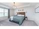 Bedroom with a wood headboard, globe chandelier, and tray ceiling at 6164 Brighton Dr, Whitestown, IN 46075
