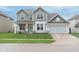 Charming two-story home featuring a well-manicured lawn, attached two-car garage, and a welcoming covered front porch at 6164 Brighton Dr, Whitestown, IN 46075