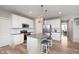 Well-designed kitchen with white cabinets, center island with seating, stainless steel appliances, and wood-look floors at 6164 Brighton Dr, Whitestown, IN 46075