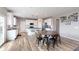 Spacious kitchen featuring white cabinets, a central island, stainless steel appliances, and an adjacent dining area at 6164 Brighton Dr, Whitestown, IN 46075