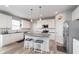 Bright kitchen with white cabinets, a gray center island with seating, stainless steel appliances, and modern pendant lighting at 6164 Brighton Dr, Whitestown, IN 46075
