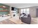 Bright and inviting living room with a fireplace, built-in shelving, stylish decor, comfortable seating, and wood-look floors at 6164 Brighton Dr, Whitestown, IN 46075