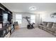 Bright living room with large built-in shelving unit, exercise bike, and plush sofa at 6164 Brighton Dr, Whitestown, IN 46075