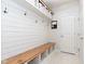Mudroom featuring built-in bench with storage, hooks on shiplap wall, and white trim at 6164 Brighton Dr, Whitestown, IN 46075