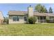 View of back of house with lawn, and screened porch at 6195 Woodmill Dr, Fishers, IN 46038