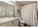 Clean, well-lit bathroom with white fixtures, a shower-tub combination, and a large mirror at 6195 Woodmill Dr, Fishers, IN 46038