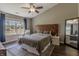 Cozy bedroom with modern furnishings, including a unique chevron headboard and ample natural light at 6195 Woodmill Dr, Fishers, IN 46038