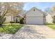 Well-maintained home with a two-car garage, green lawn, and mature landscaping, presenting great curb appeal at 6195 Woodmill Dr, Fishers, IN 46038