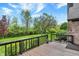 Wooden deck overlooking a backyard with a lush lawn and mature trees at 621 Thorne Dr, Brownsburg, IN 46112
