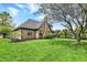 Beautiful backyard featuring a brick house, well-kept lawn, mature trees, and professional landscaping at 621 Thorne Dr, Brownsburg, IN 46112