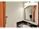 Well-lit bathroom featuring a granite countertop, mirror, and towel rack at 621 Thorne Dr, Brownsburg, IN 46112
