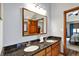 Bathroom featuring a double sink vanity with dark granite countertops and wood cabinets at 621 Thorne Dr, Brownsburg, IN 46112