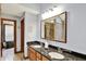 Bathroom with dual sinks, granite counters, stone shower, and a walk-in closet at 621 Thorne Dr, Brownsburg, IN 46112