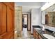 Bathroom with dual sinks, granite counters, stone shower, and a walk-in closet at 621 Thorne Dr, Brownsburg, IN 46112