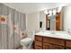 Bathroom features a toilet, patterned shower curtain, and wood vanity for a functional design at 621 Thorne Dr, Brownsburg, IN 46112