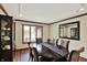 Traditional dining room boasts wood floors, dark wood trim, and a large dark wood table with seating for six at 621 Thorne Dr, Brownsburg, IN 46112