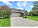 Long driveway leading to a well-maintained brick home with a two-car garage at 621 Thorne Dr, Brownsburg, IN 46112