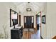 Elegant entryway with dark wood floors, chandelier, and statement mirror at 621 Thorne Dr, Brownsburg, IN 46112