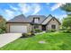 Charming brick home featuring a well-manicured lawn and a two-car garage at 621 Thorne Dr, Brownsburg, IN 46112