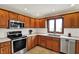 Updated kitchen featuring stainless steel appliances, oak cabinetry, and bright countertops at 621 Thorne Dr, Brownsburg, IN 46112