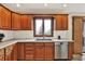 Well-lit kitchen featuring updated stainless steel appliances and oak cabinetry at 621 Thorne Dr, Brownsburg, IN 46112