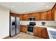 Bright kitchen featuring stainless steel appliances, oak cabinets and tile flooring at 621 Thorne Dr, Brownsburg, IN 46112