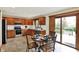 Bright kitchen featuring granite countertops, stainless steel appliances, and a breakfast nook leading to an outdoor deck at 621 Thorne Dr, Brownsburg, IN 46112