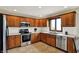 Modern kitchen features stainless steel appliances, white subway tile backsplash, and oak cabinets at 621 Thorne Dr, Brownsburg, IN 46112