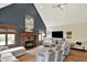 Bright living room features a fireplace, vaulted ceiling, and comfortable seating at 621 Thorne Dr, Brownsburg, IN 46112