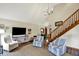 Welcoming living room with staircase, features comfortable seating and natural light at 621 Thorne Dr, Brownsburg, IN 46112