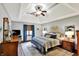 Spacious bedroom with tray ceiling, ceiling fan, and ample natural light at 621 Thorne Dr, Brownsburg, IN 46112